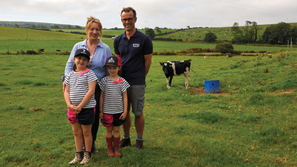 Alex Pritchard with daughters Florence and Jemim) and vet Ryan Davies in a field alongside a calf