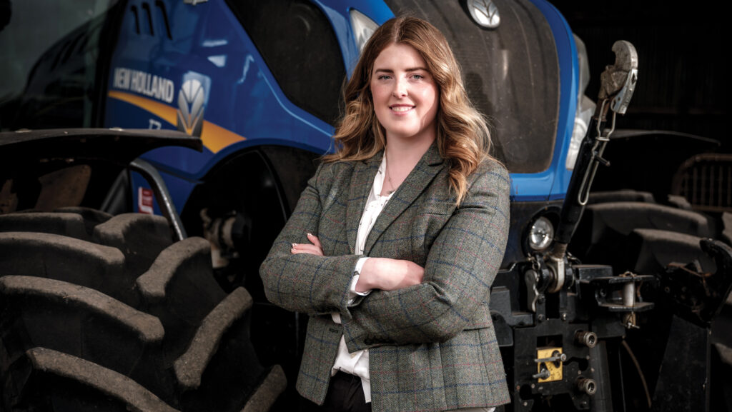 Caryl Davies standing in front of a tractor