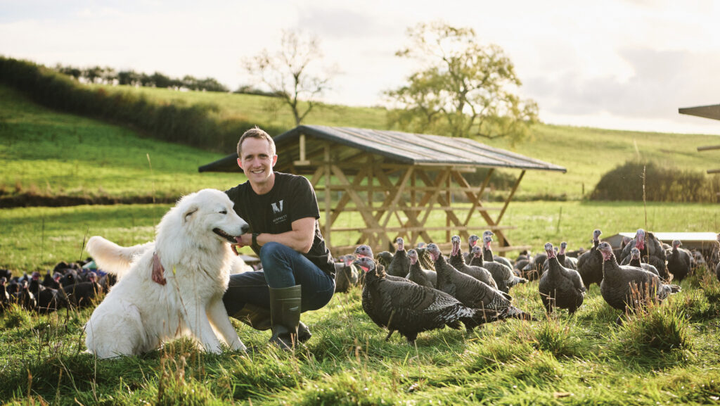 George Ford with dog and turkeys