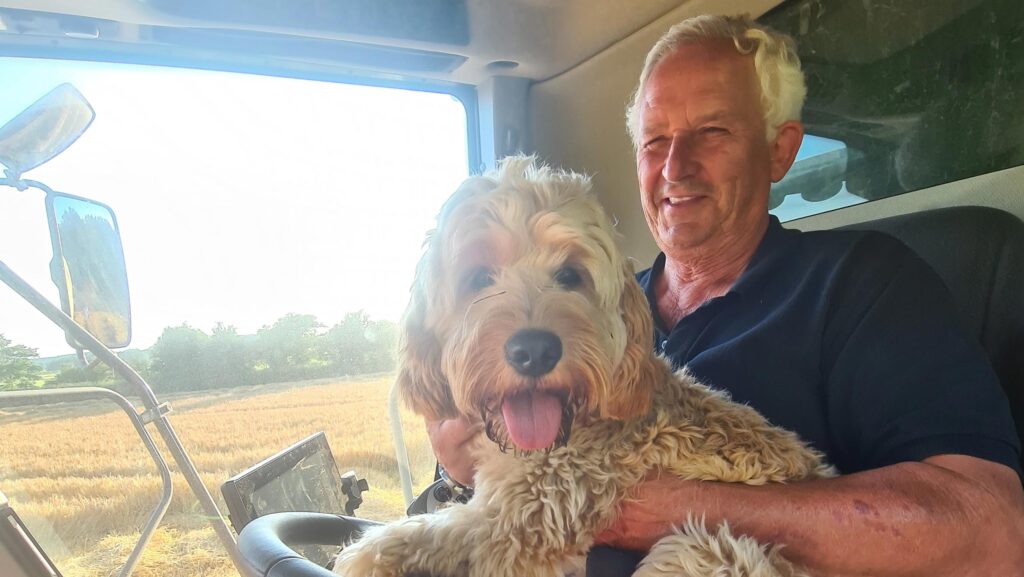 Glen Sanderson in tractor with dog