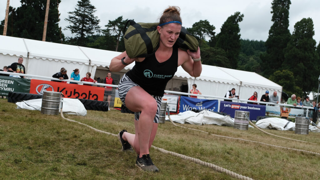 Katie Bleekman performing lunges with a weighted bag