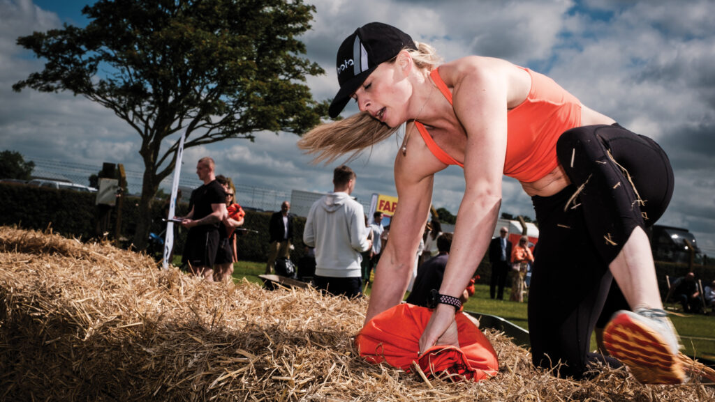 Lindsay Benson climbing a bale