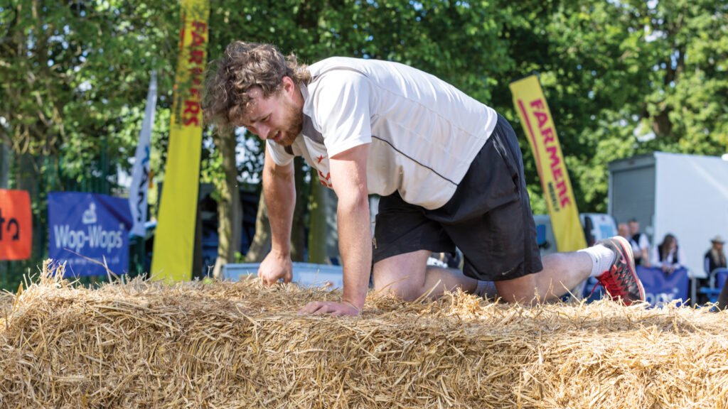 Oliver Varley climbing a bale