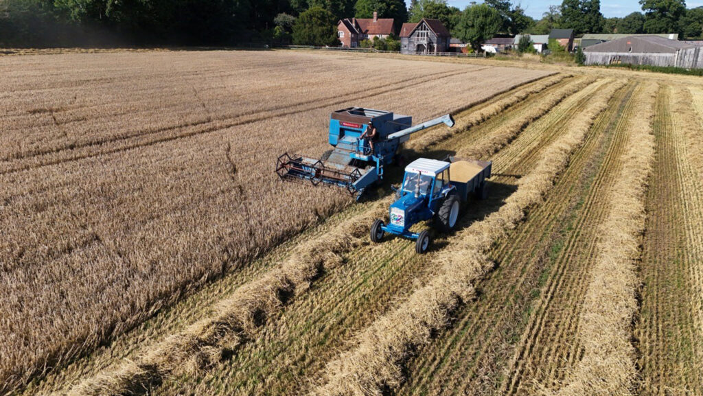 A combine and a tractor in a UK field