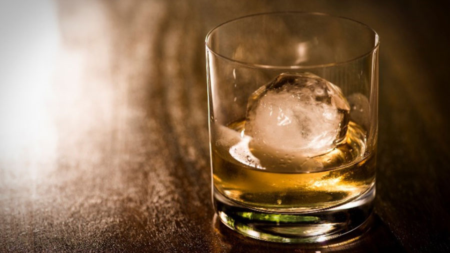 Whisky in a glass with an ice cube