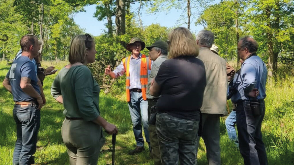 Jonathan Plowe with crowd in a forest