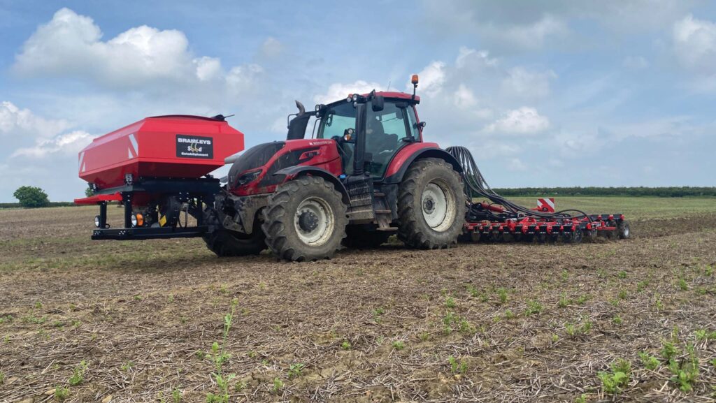 Drill and tractor with front-mounted hopper