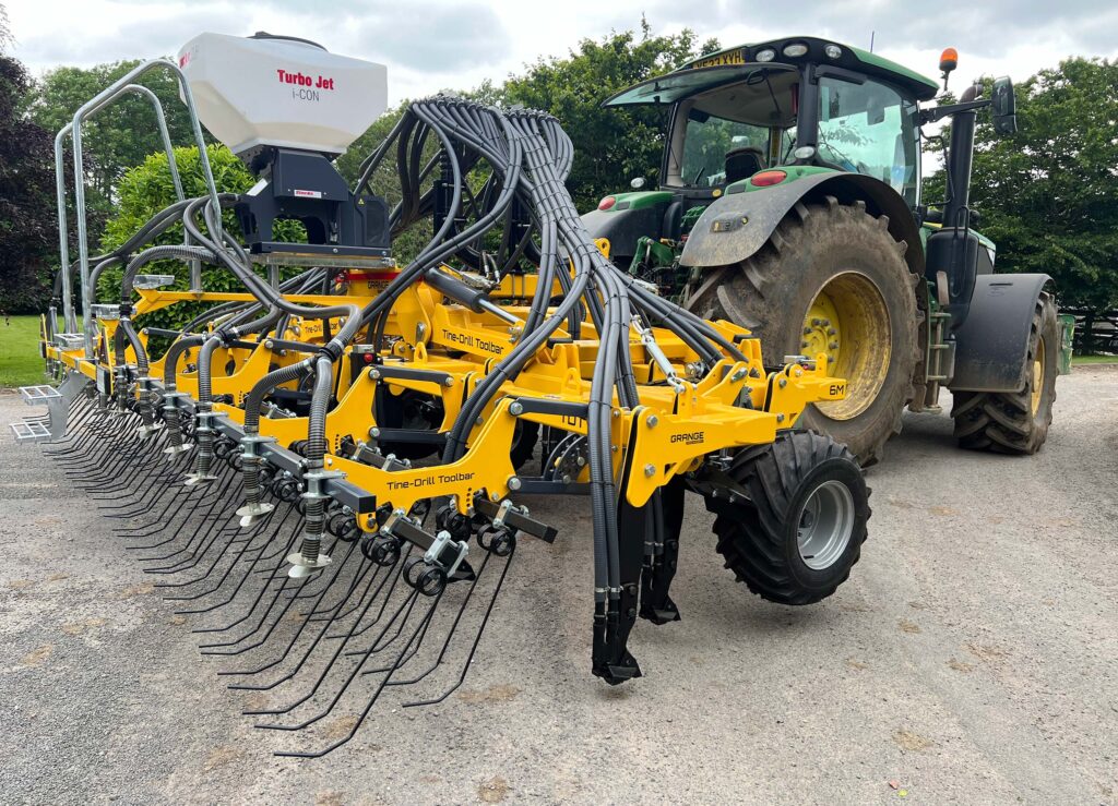 Drill and tractor in a farmyard