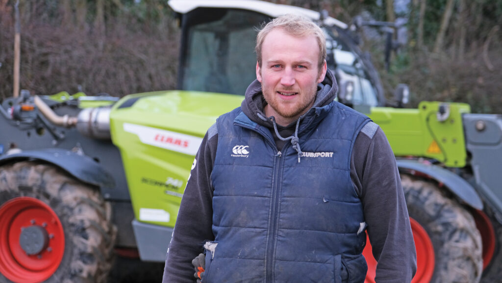 Harry Whiteman standing in front of a tractor