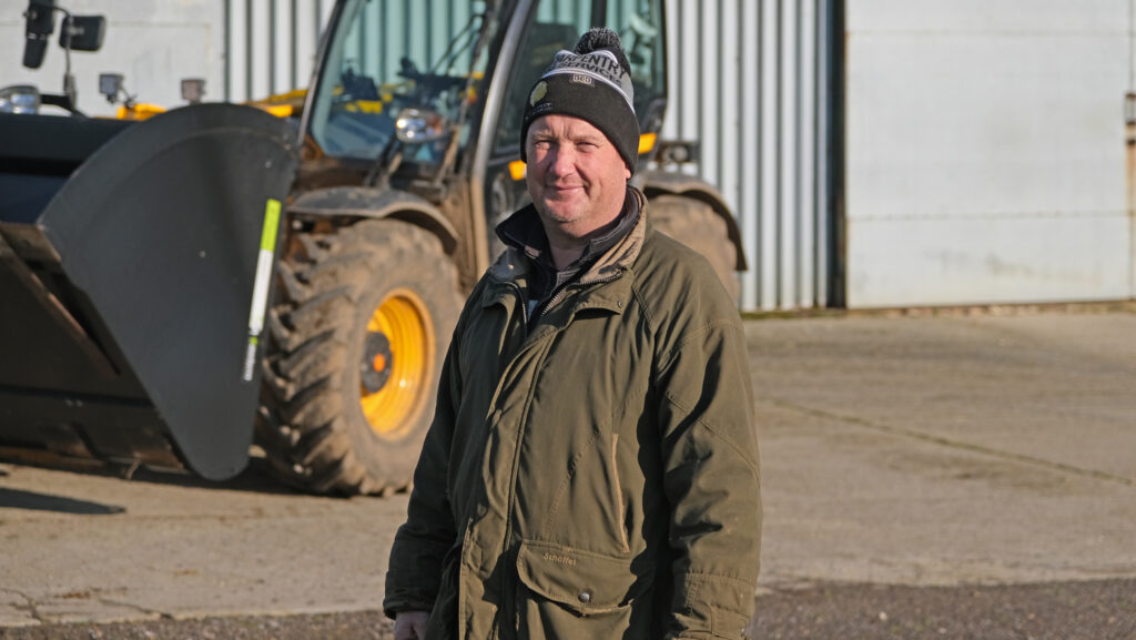 John Walker standing in front of a tractor