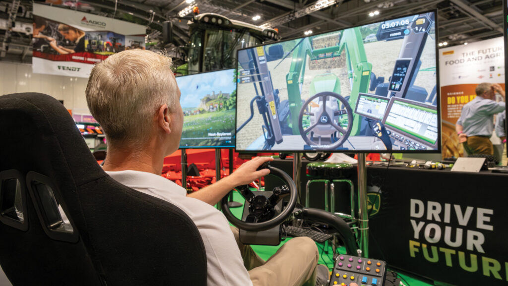 Person sitting a tractor simulator at New Scientist Live 2023 exhibition