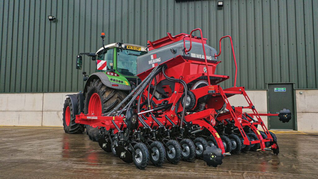 Drill and tractor parked in a farmyard