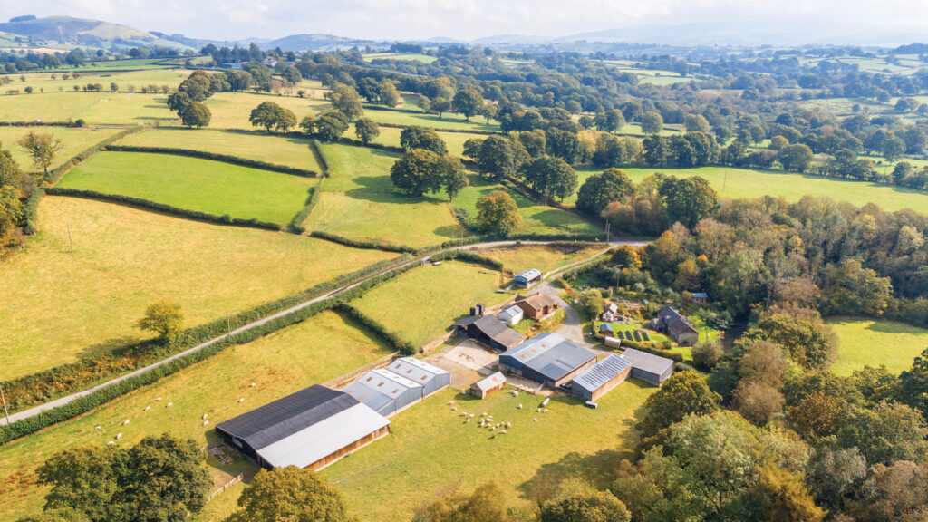 Aerial view of farmland and farm buildings at Coedtrewernau 