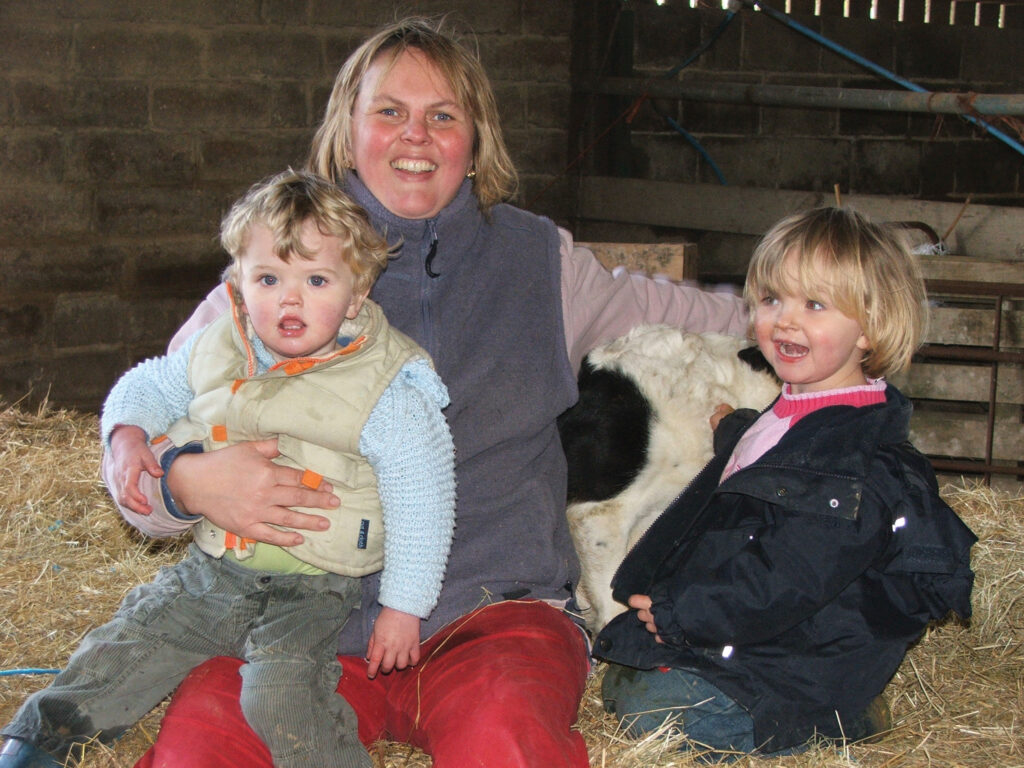 Rebecca Hill with two children on farm around 2006