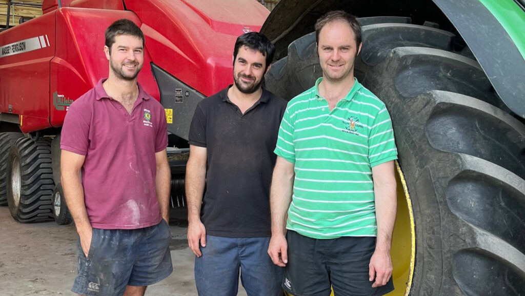 Rich, Mike and Bobb Barnes standing next to a tractor