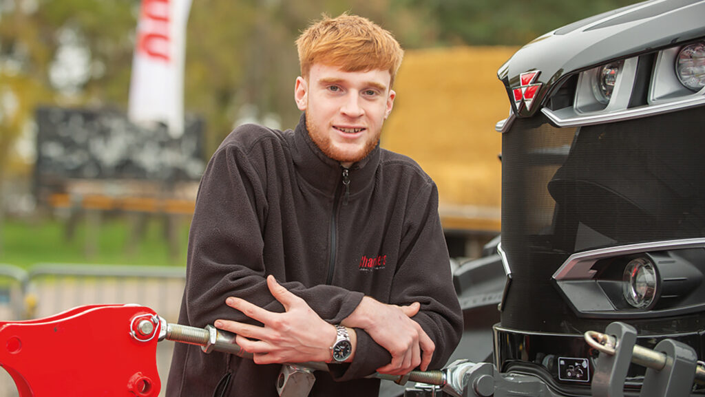 Young man leaning on a tractor