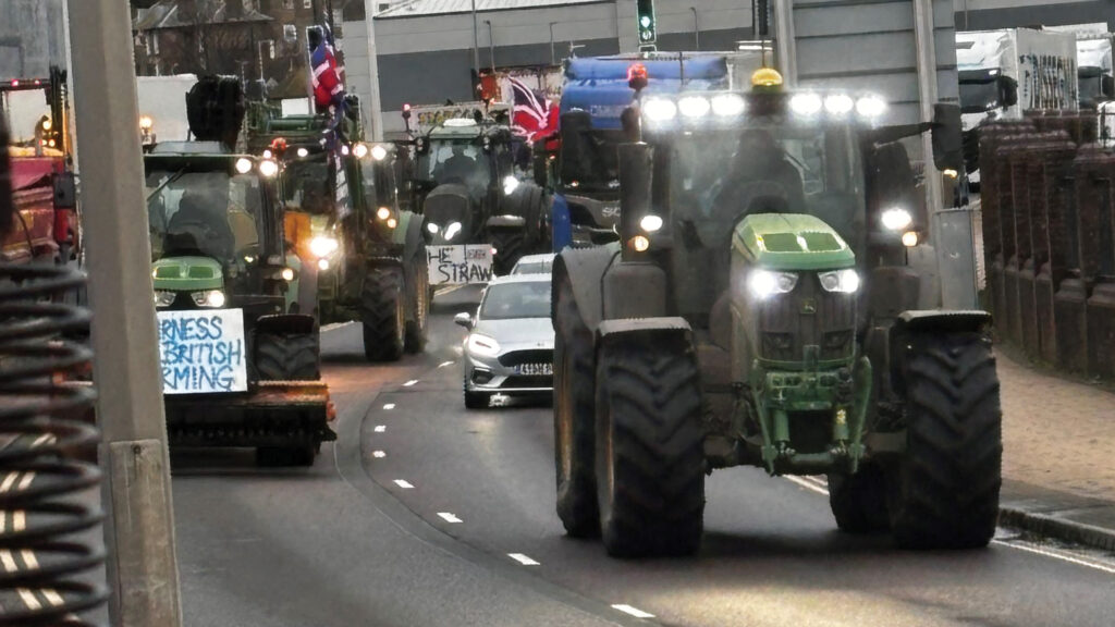 Tractors on a road with lights on