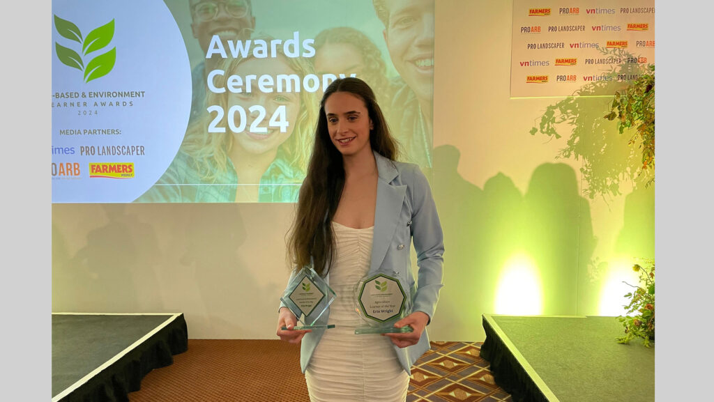 Erin Wright holding two awards