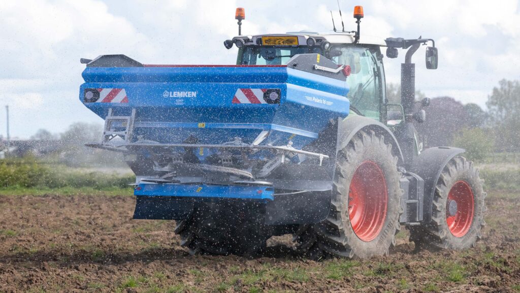 Tractor spreading granular fertiliser