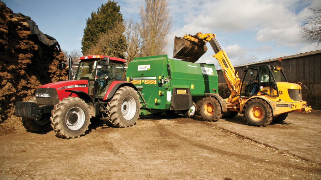 Machinery loading silage