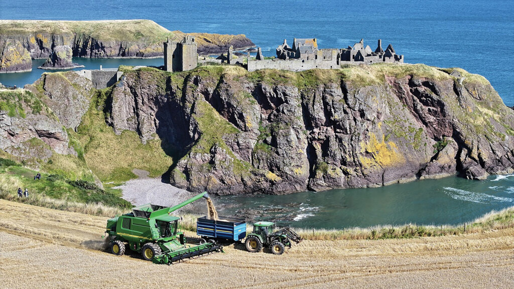 Aerial shot of combine harvester on coastline