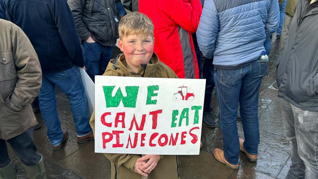 Boy holding a placard at farming protest