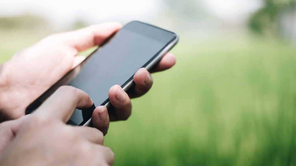 A close up of a male holding a mobile phone