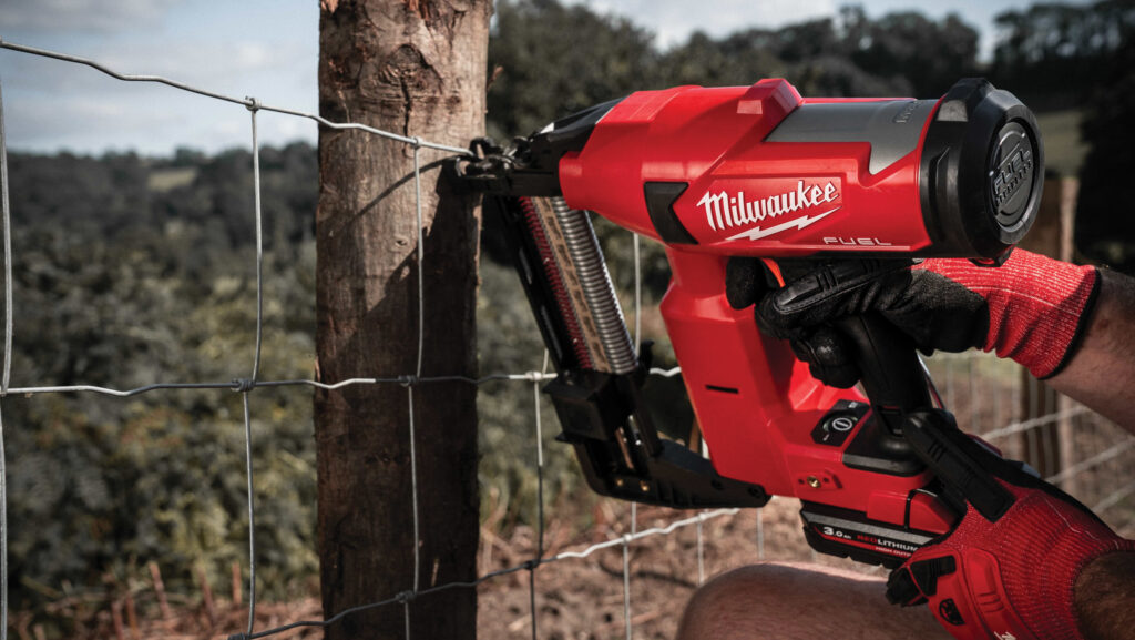 Staple gun being used on a fence