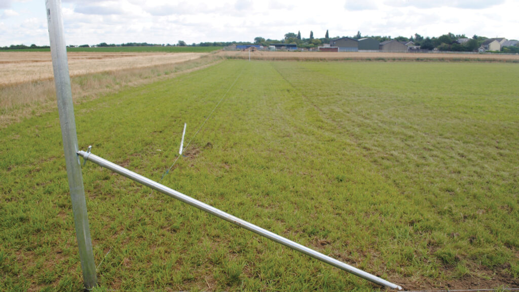 Metal fence post with a metal support arm