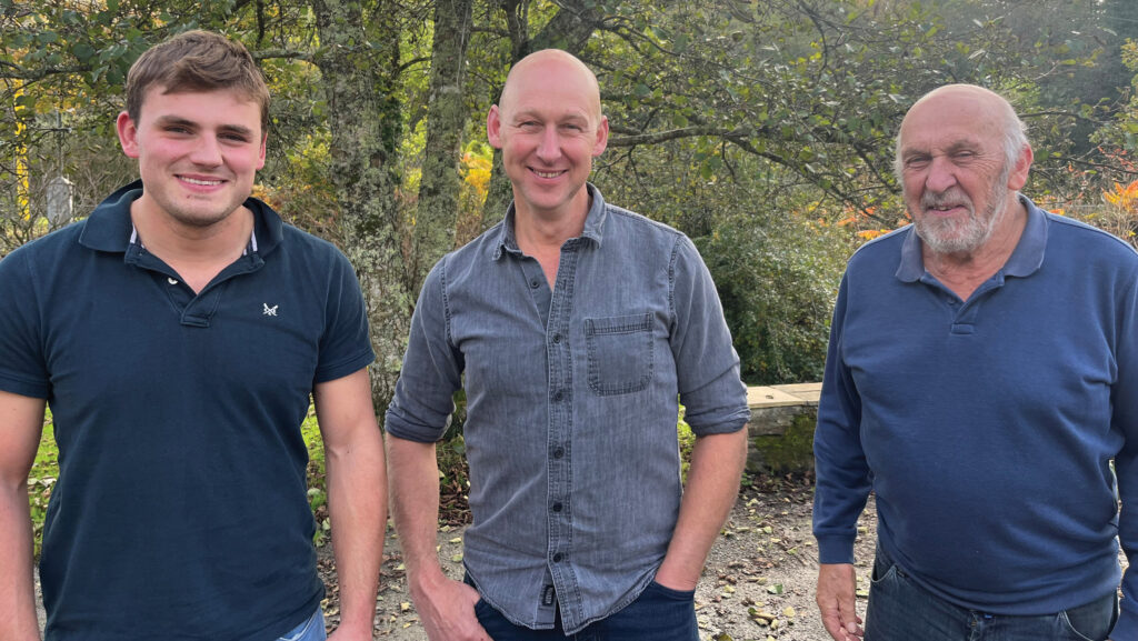 Andrew, Matthew and Joe Rowe in front of trees