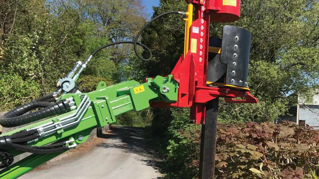 Telehandler arm with post driver attached