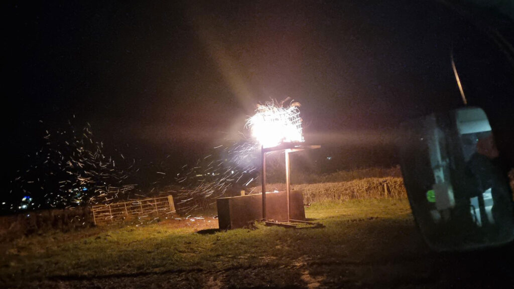 A lit beacon on a farm