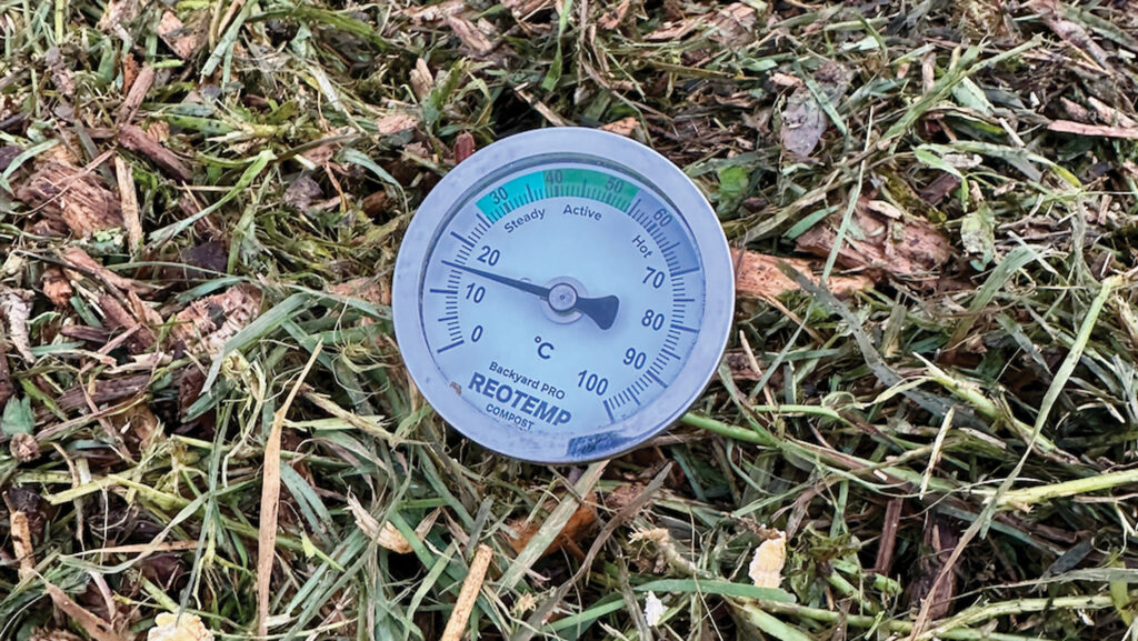 Dial thermometer in compost heap