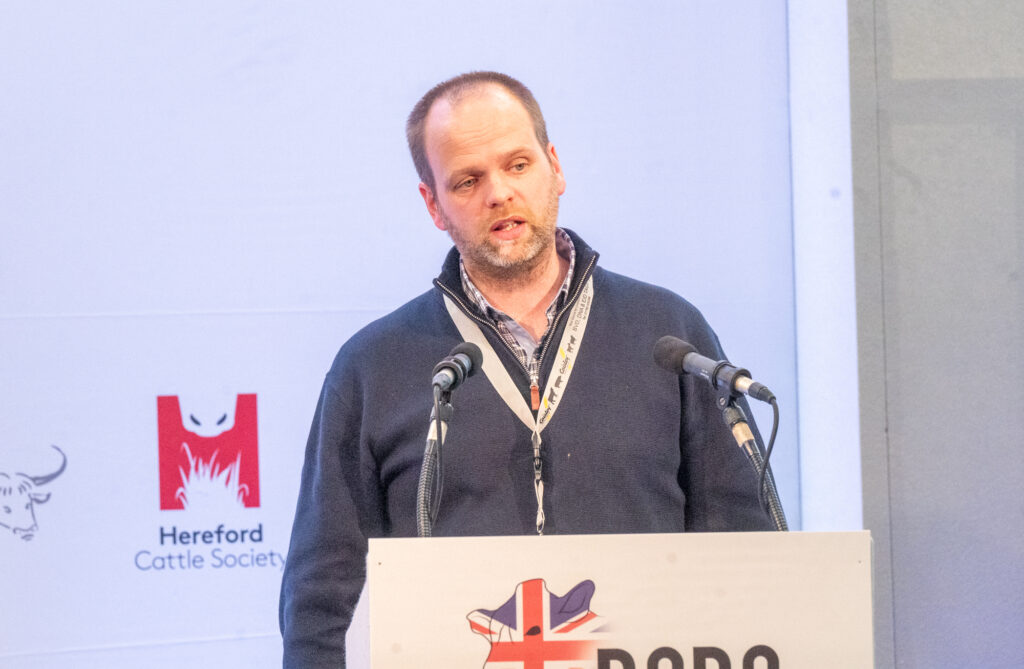 James Leslie standing at a podium