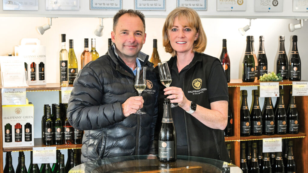 Couple in winery shop with champagne flutes