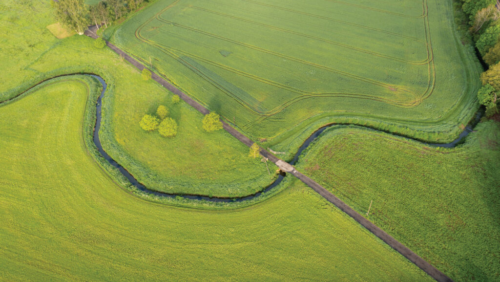 Bird's eye view of farmland with a winding river