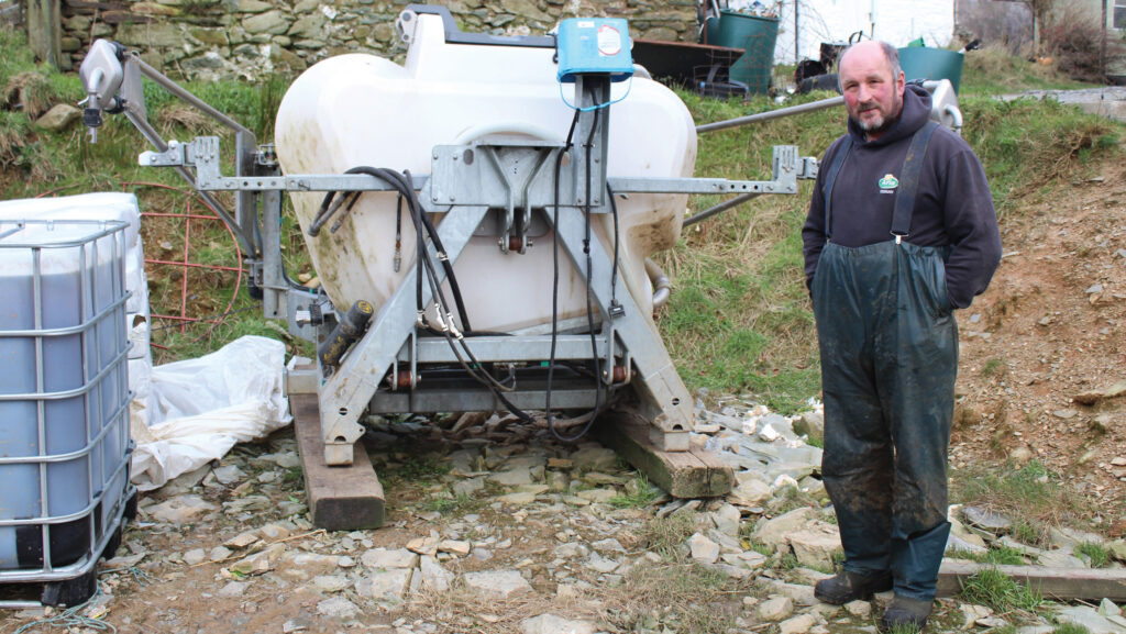 A man with a Tow and Fert machine