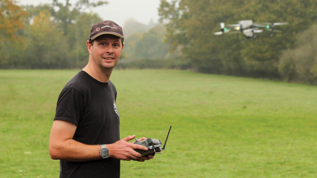 Steve Frost flying a drone in a field