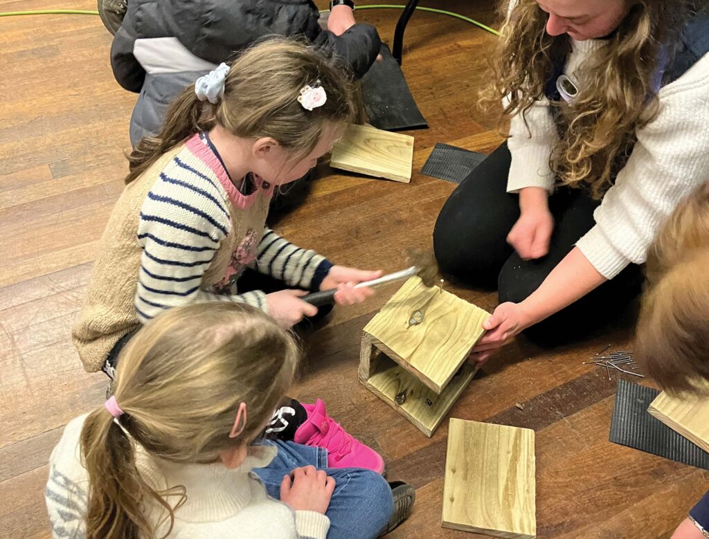 Children and adults making bird boxes