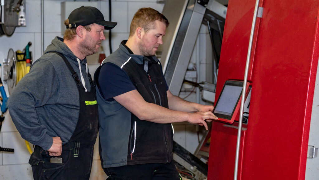 Farmers check the log data of a milking robot