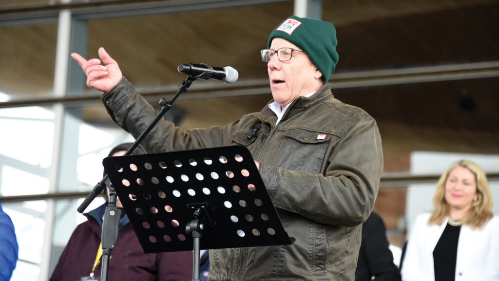 Man addressing an outdoor meeting