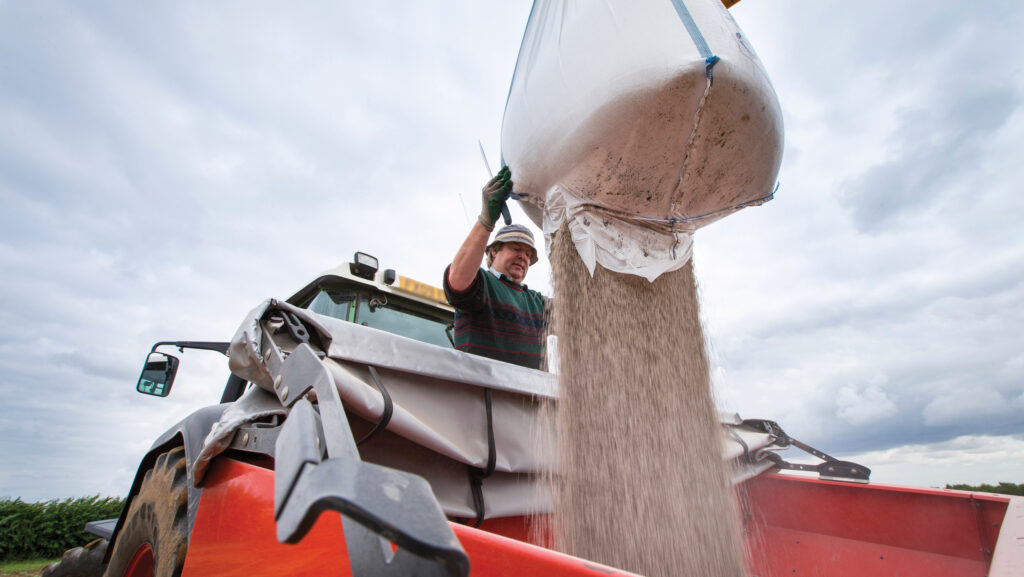 A fertiliser spreader being loaded