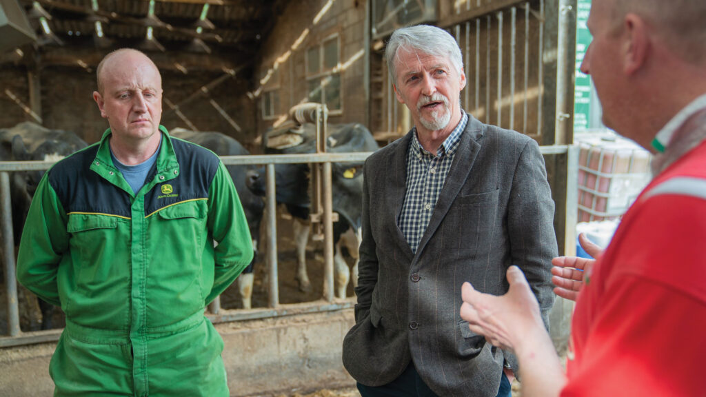 Three men talking on a farm