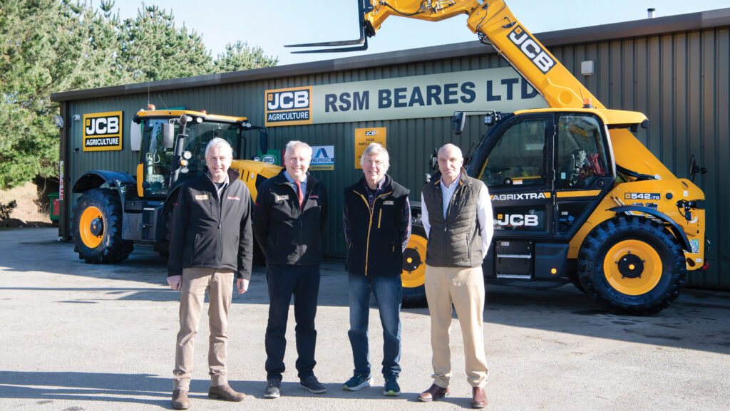 Group of men in front of machinery