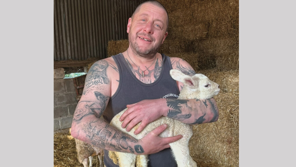 Stephen Crisp holding a lamb