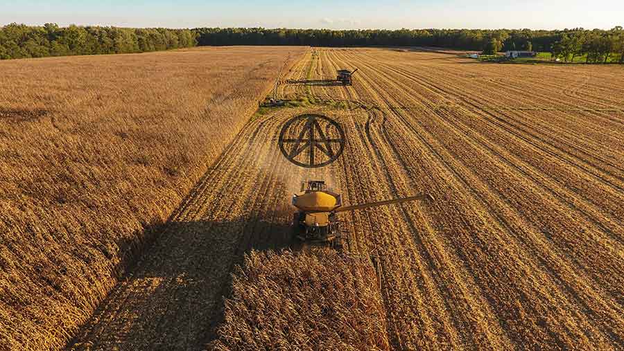 Combine harvester in field