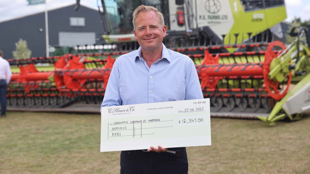 Man holds up an oversized cheque