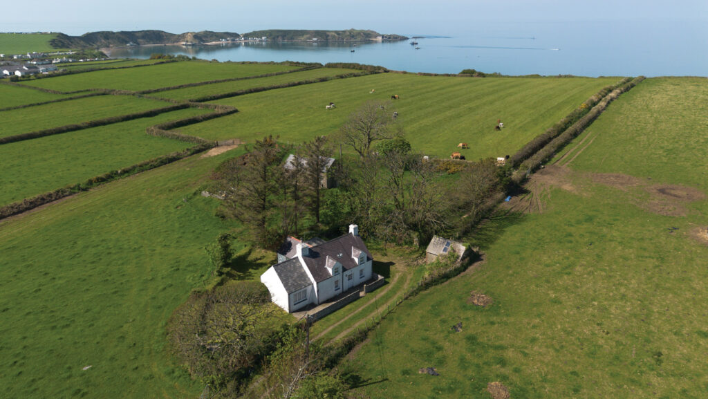 Aerial view of farmland with sea behind