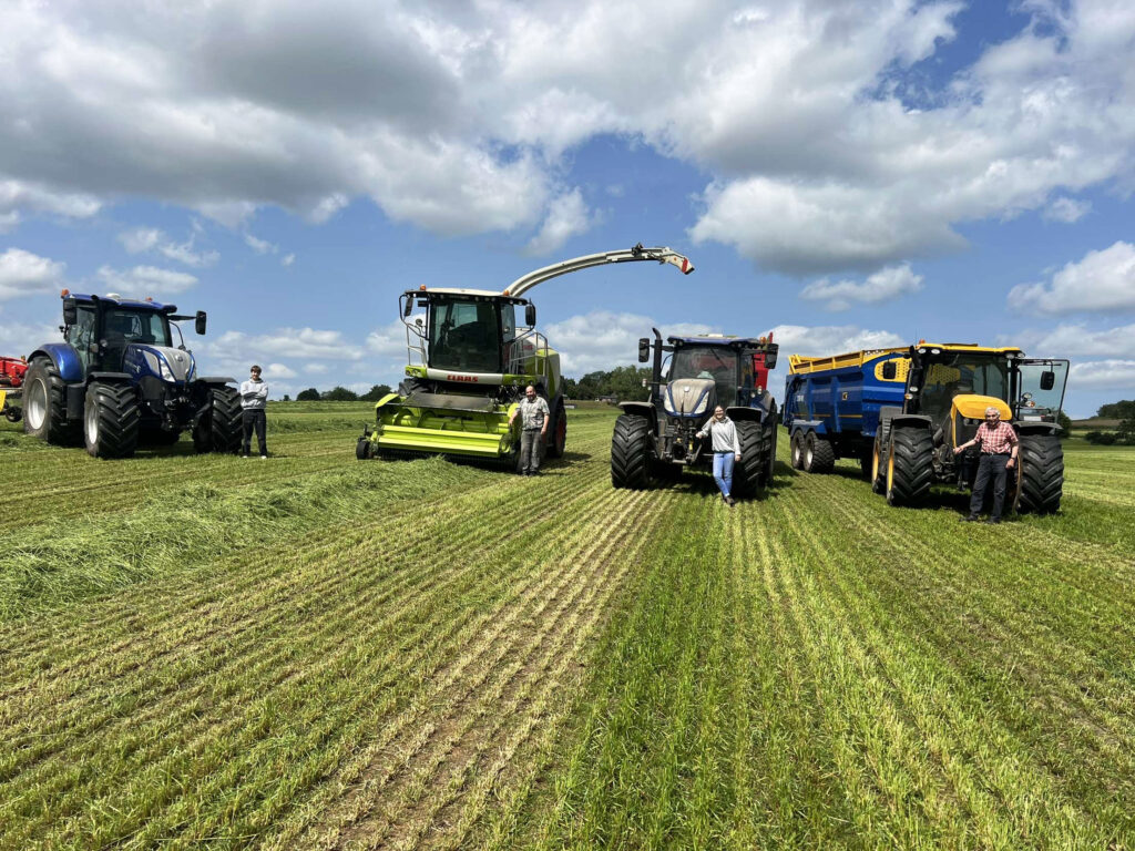 The Robinsons standing by their silaging equipment