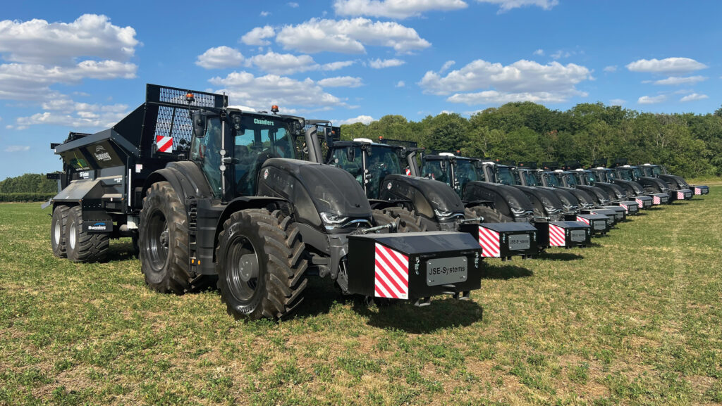 Row of new tractors in a field